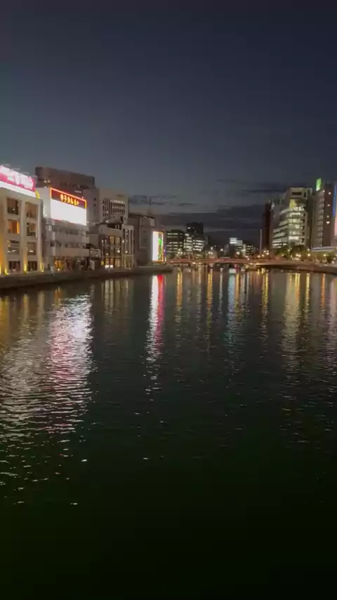 The Naka River at night with neon signs from Nakasu reflecting in the water